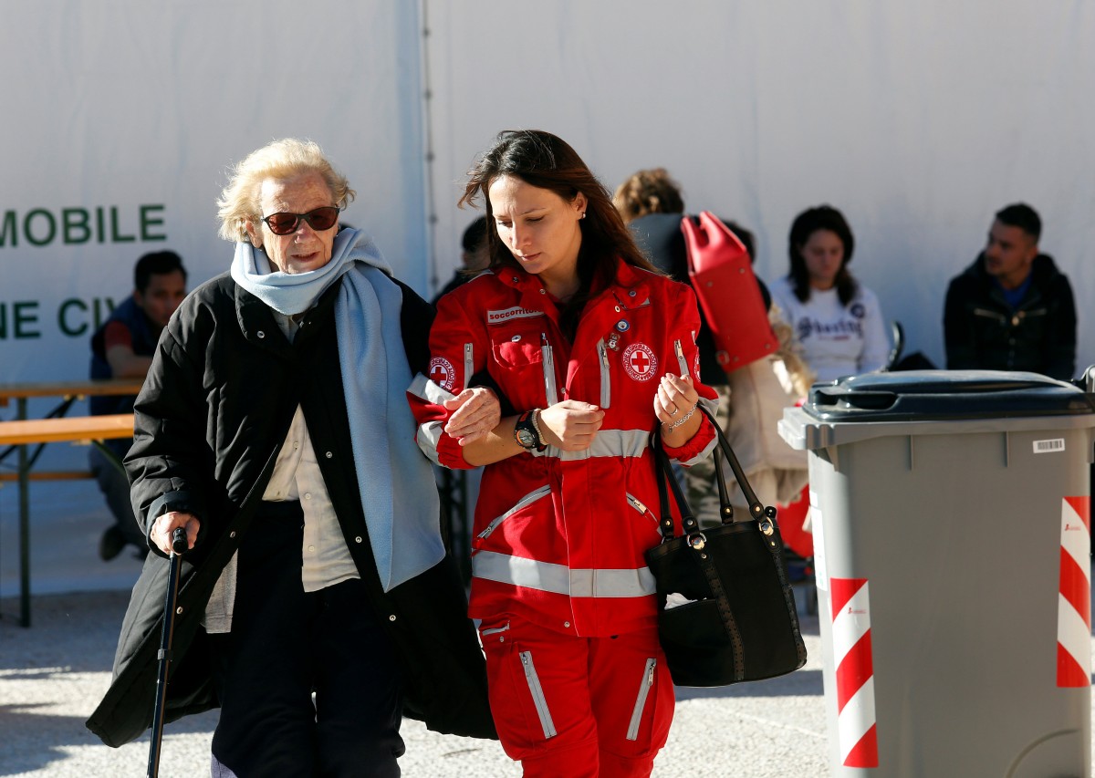 Una mujer es atendida por un miembro de la Cruz Roja italiana en Norcia | FPTP: REUTERS/Remo Casilli  FOR EDITORIAL USE ONLY. NO RESALES. NO ARCHIVES