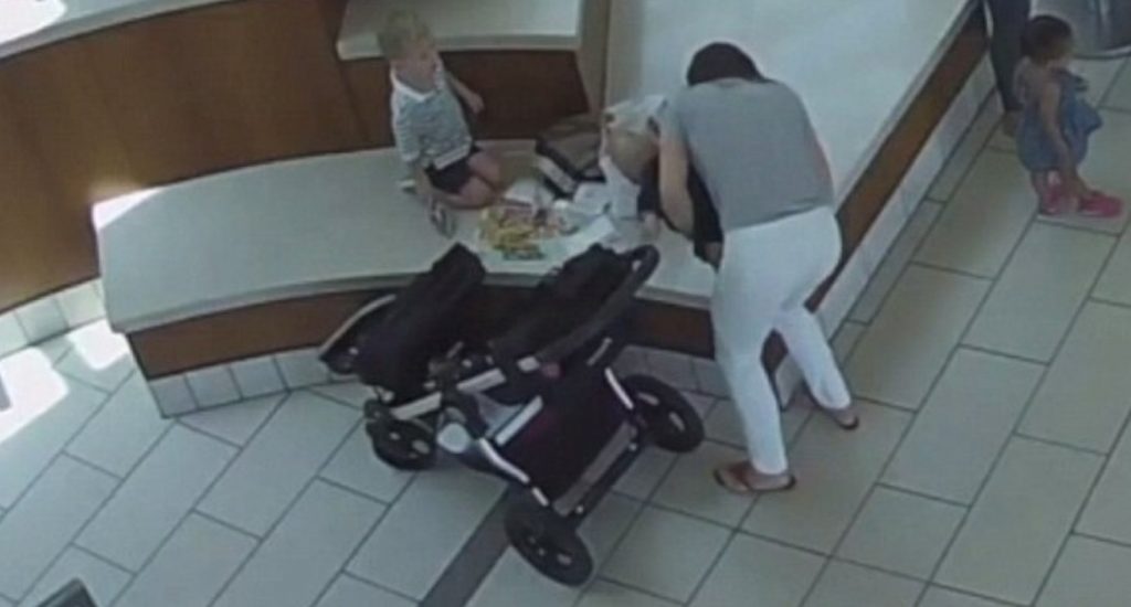 Ana Graham, con la pequeña Lucía en brazos para intentar sacarle el trozo de pollo. / DAILY MAIL