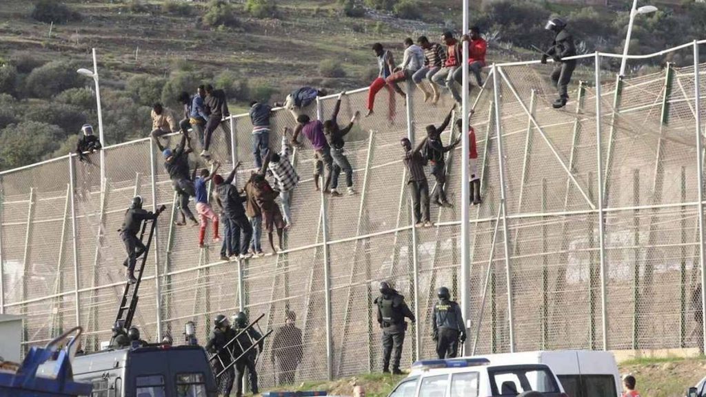 Imagen de inmigrantes encaramados a la valla de Melilla./ Efe