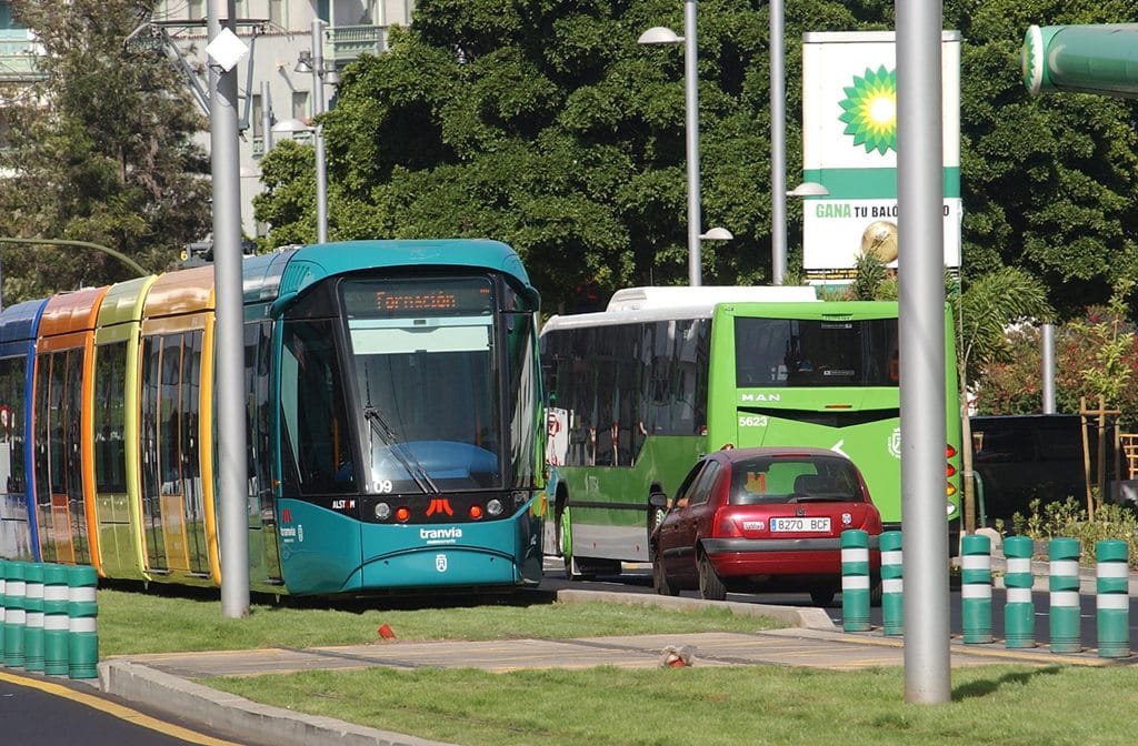 Imagen de un tranvía y una guagua circulando por una calle de Santa Cruz de Tenerife.