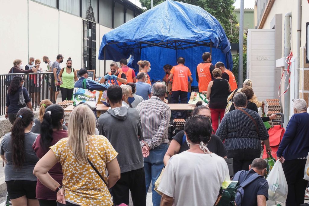 Tinerfeños hacen cola en una asociación de reparto de alimentos, algunos derivados desde Servicios Sociales. DA